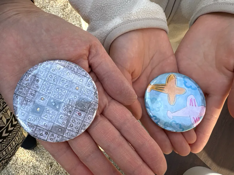 Button badges in the palm of a hand