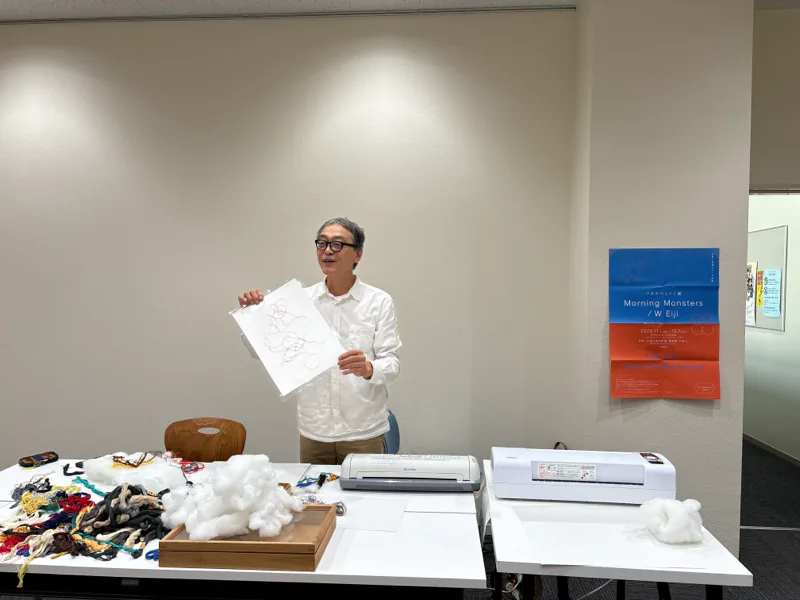 Eiji Watanabe (artist) holding up a drawing